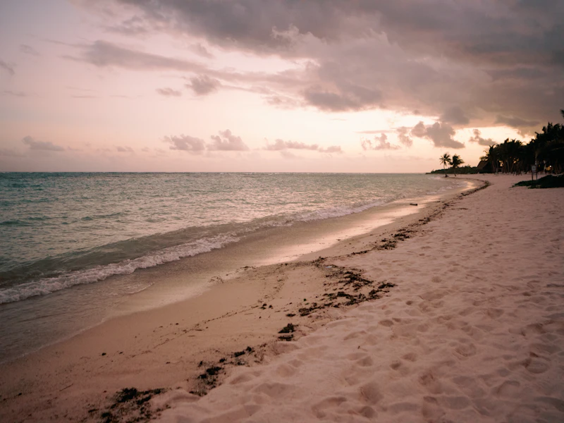 Footprints on a quiet sandy beach at Tankah, near Tulum, Mexico