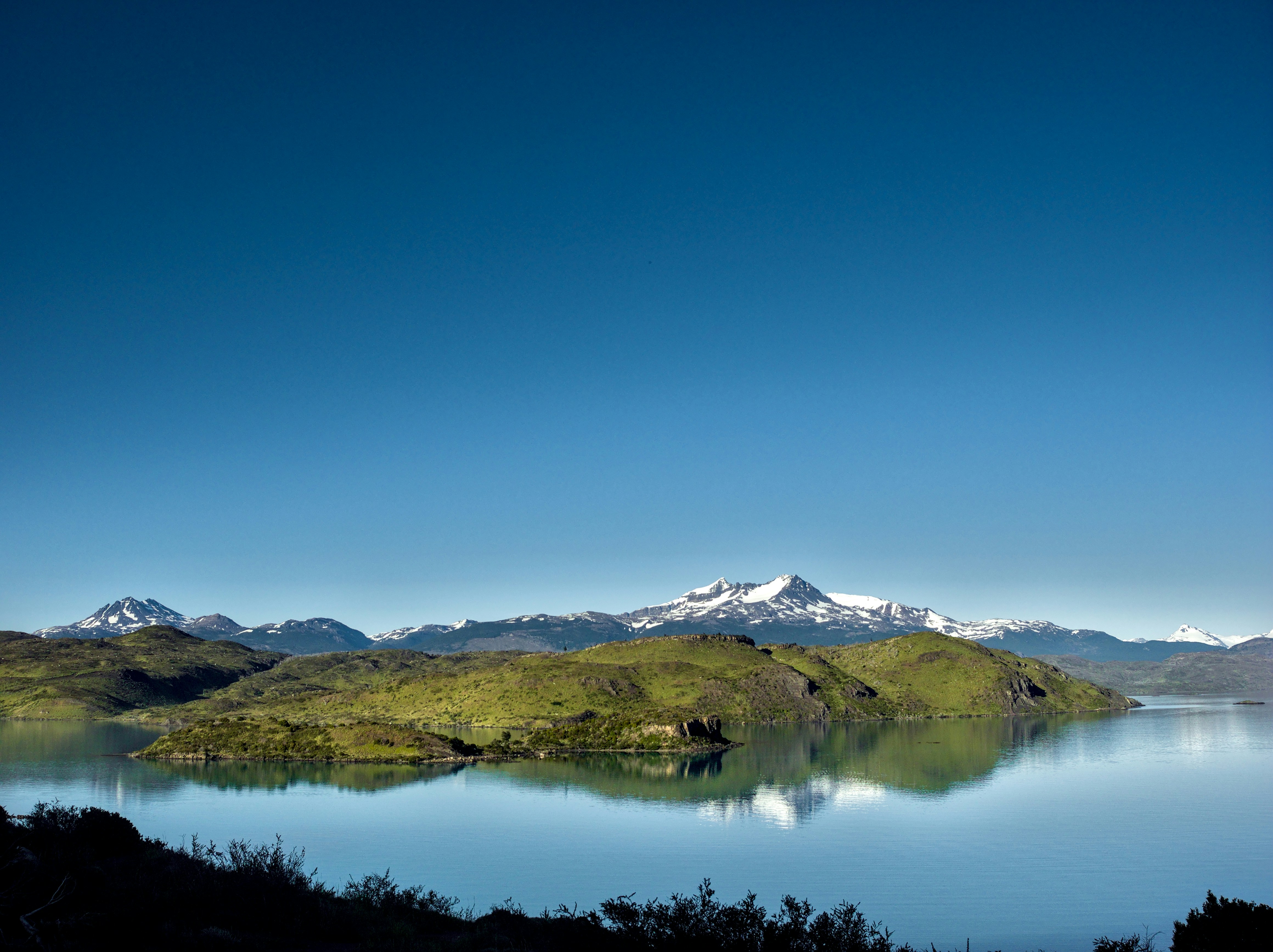 A large body of water surrounded by mountains