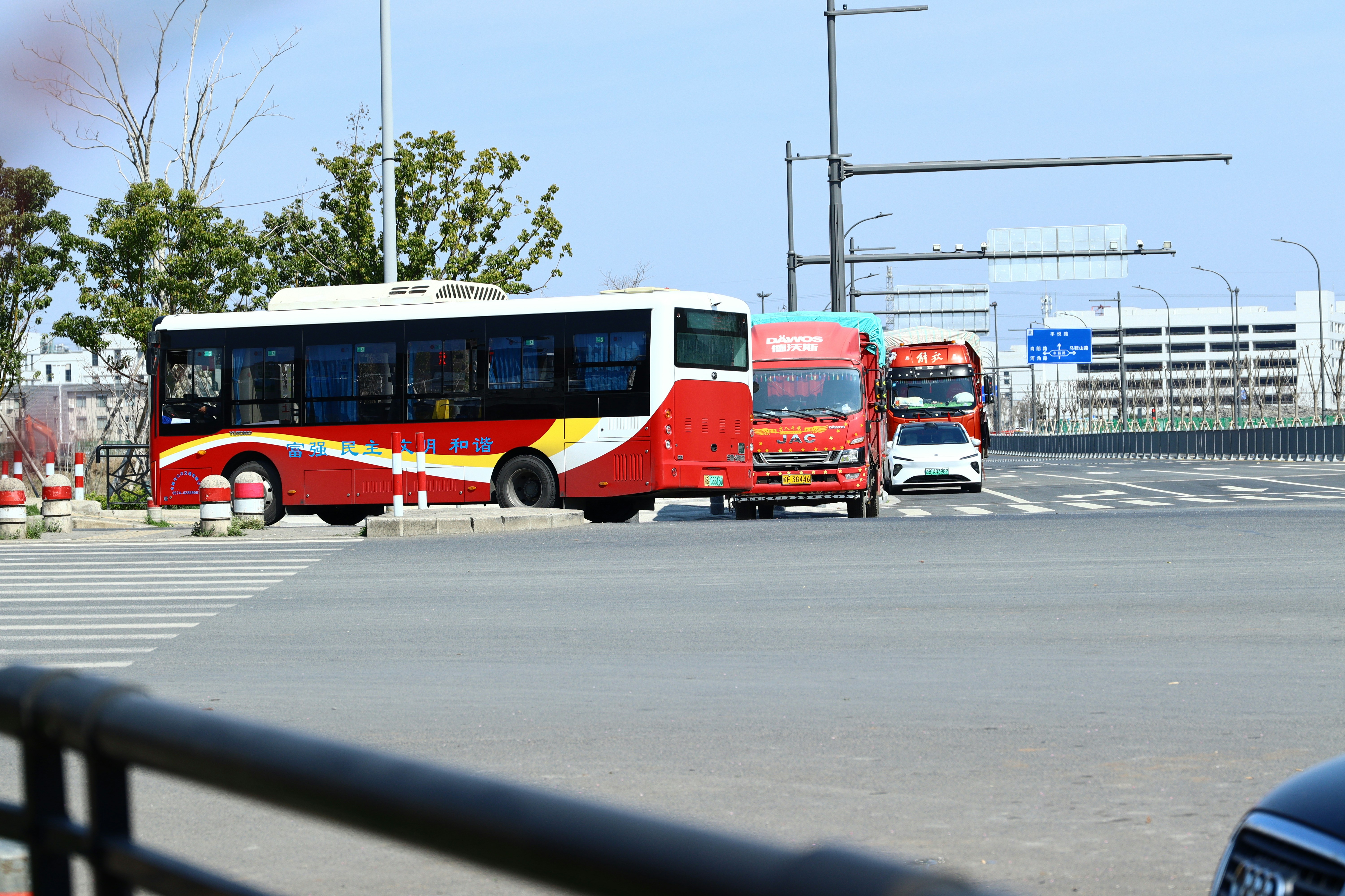 A red and yellow bus driving down a street