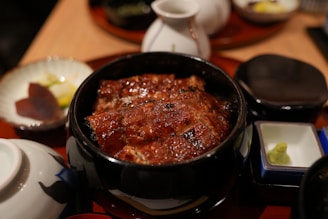 A table topped with plates and bowls of food