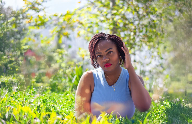 Relaxed BBW woman sitting in the grass