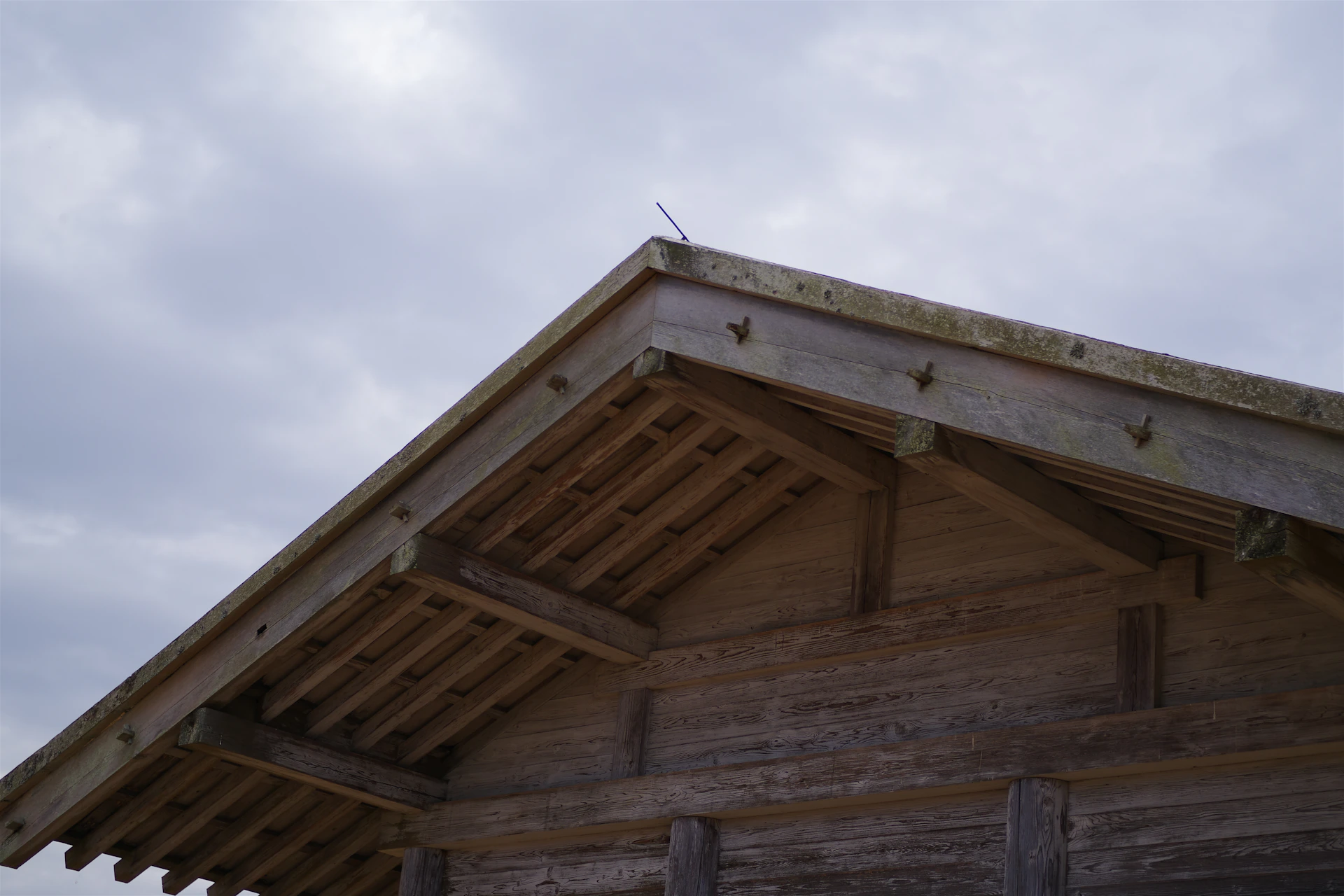 A wooden building with a sky background