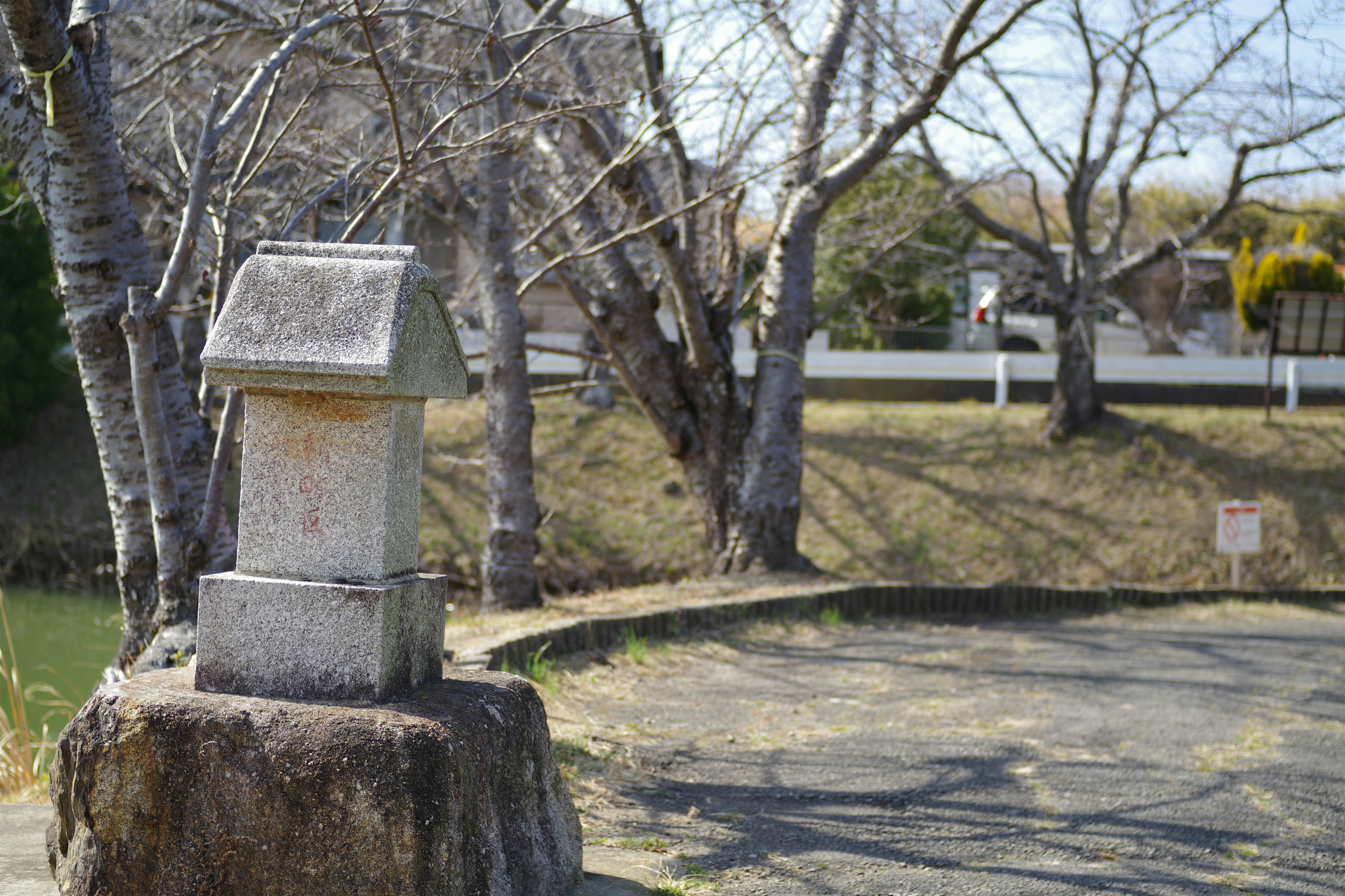 A stone monument sitting on the side of a road