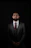 A man in a suit and tie standing in the dark