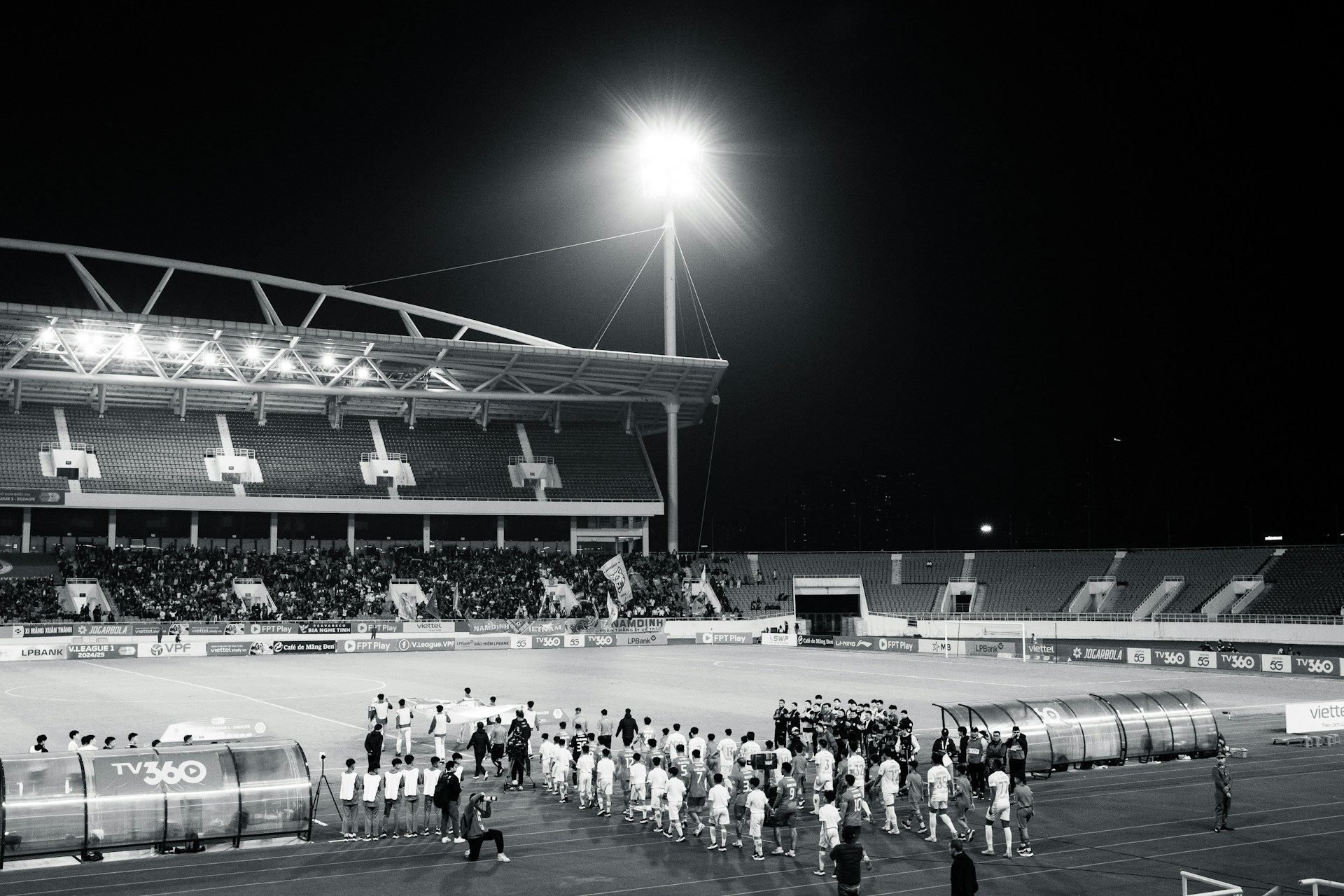 A crowd of people standing on top of a baseball field