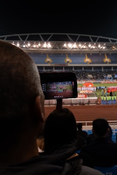 A crowd of people watching a horse race