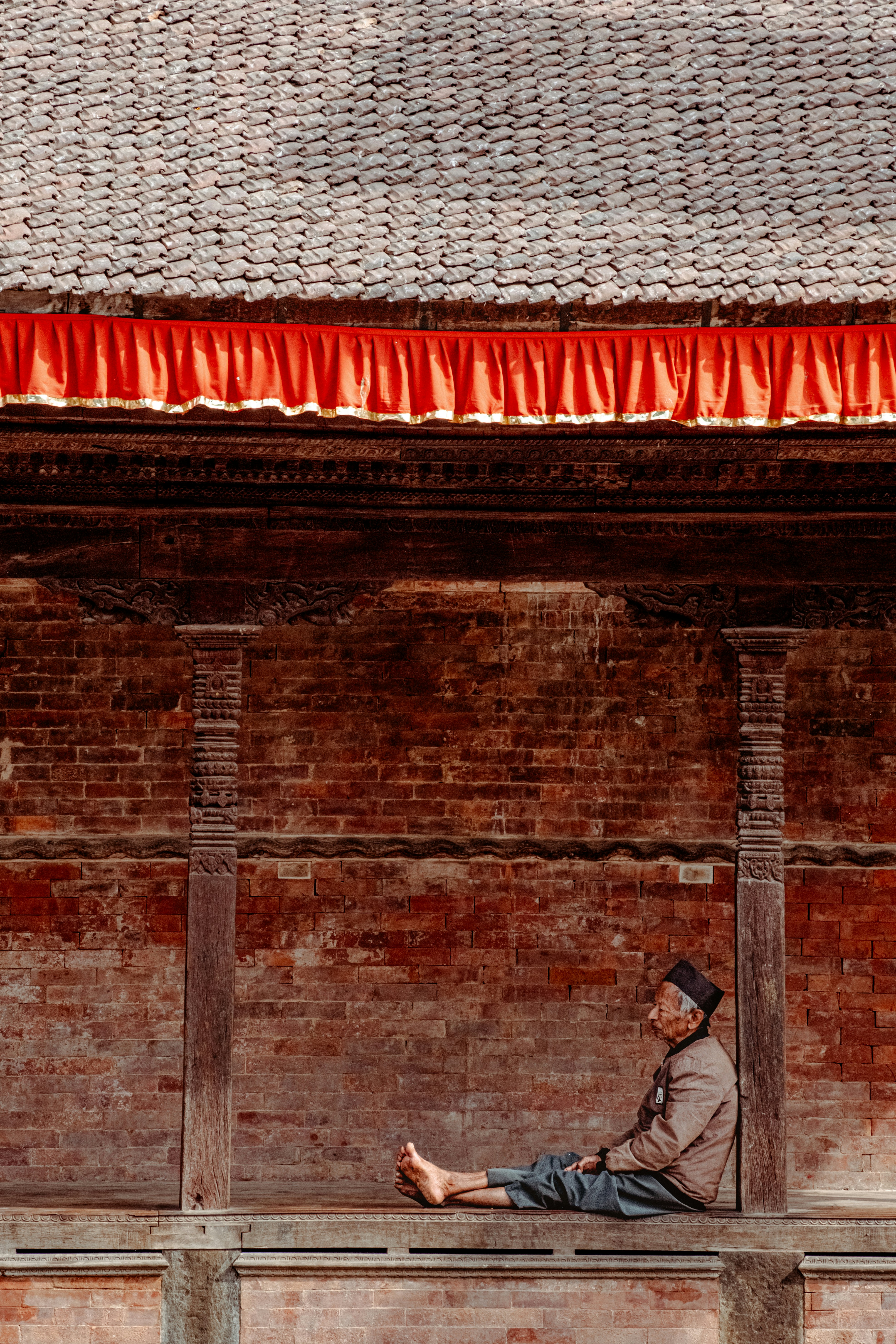A man sitting on a balcony with his feet up
