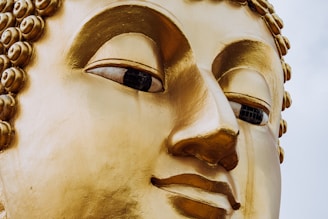 A close up of a golden buddha statue