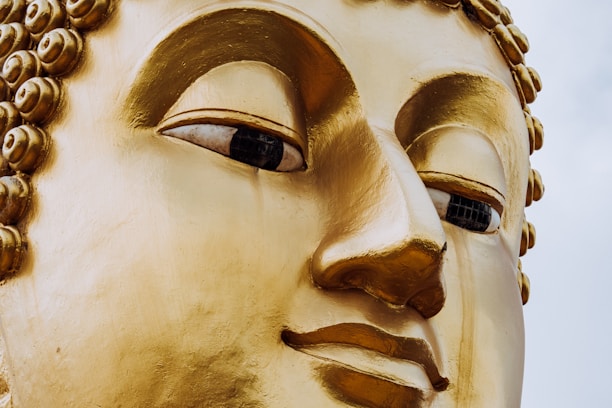 A close up of a golden buddha statue