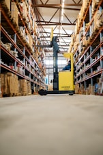 A yellow forklift in a large warehouse