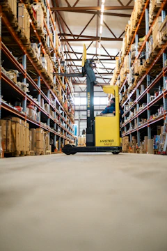 A yellow forklift in a large warehouse