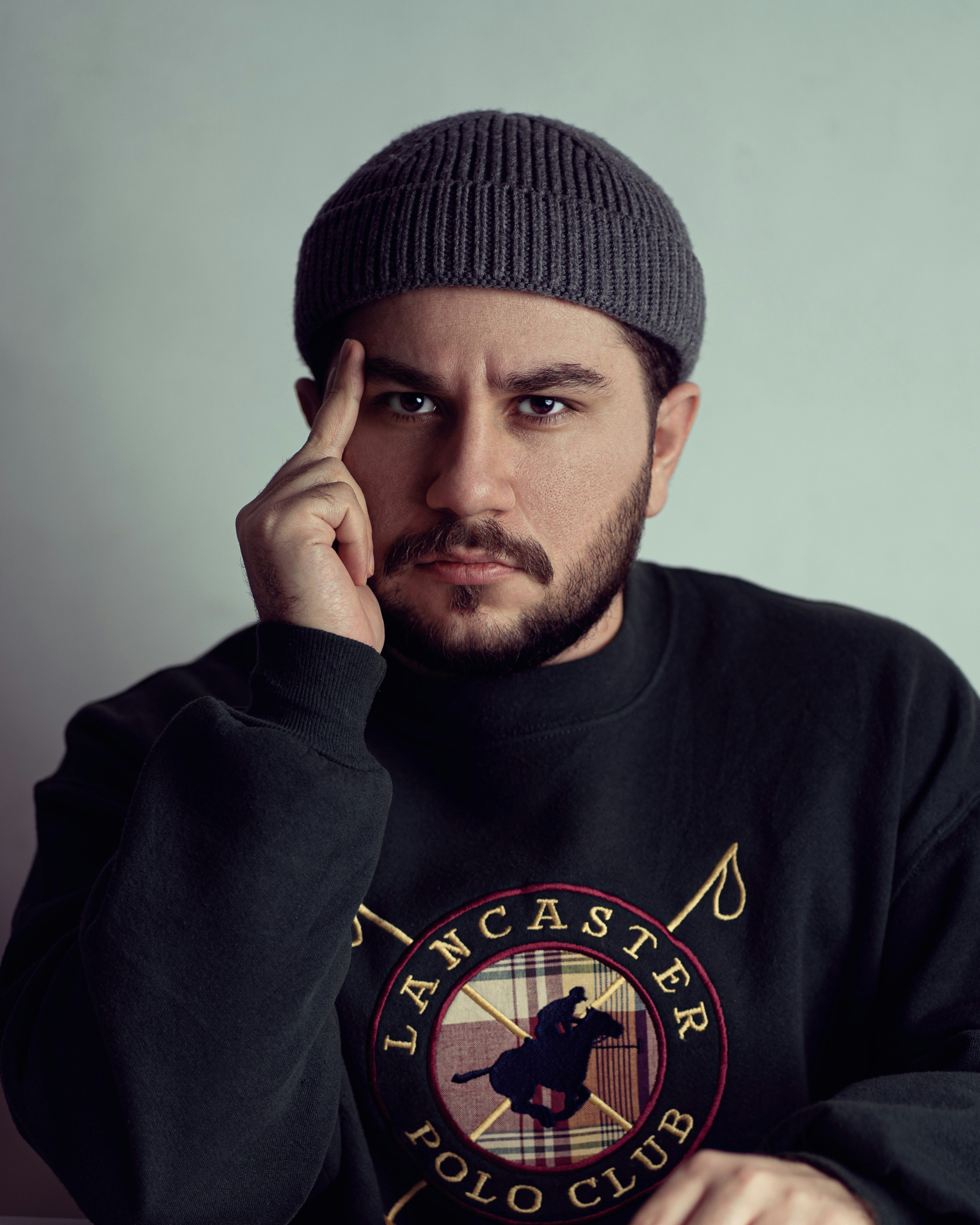 A man sitting at a table with a laptop computer