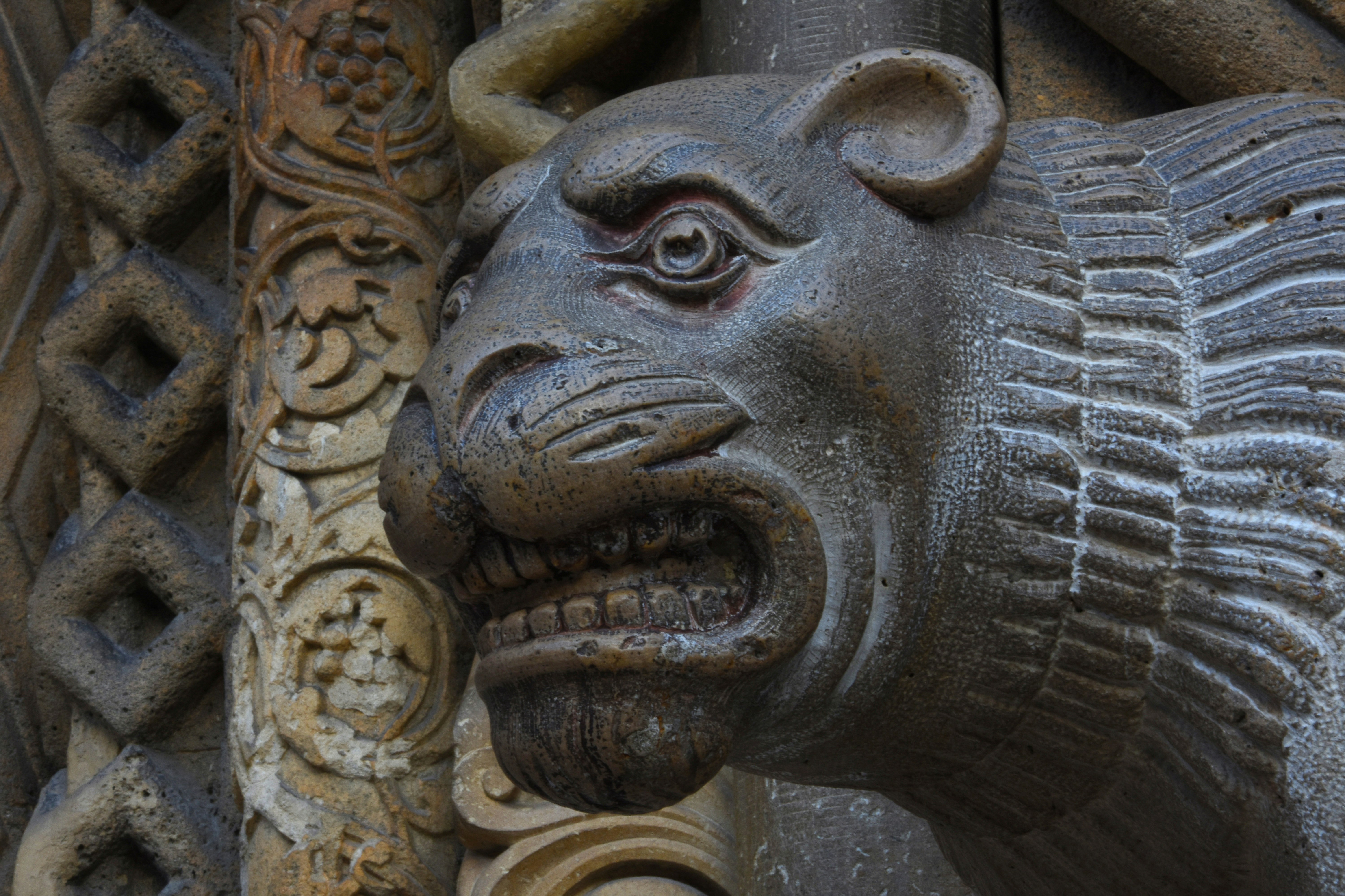 A close up of a lion head on a building