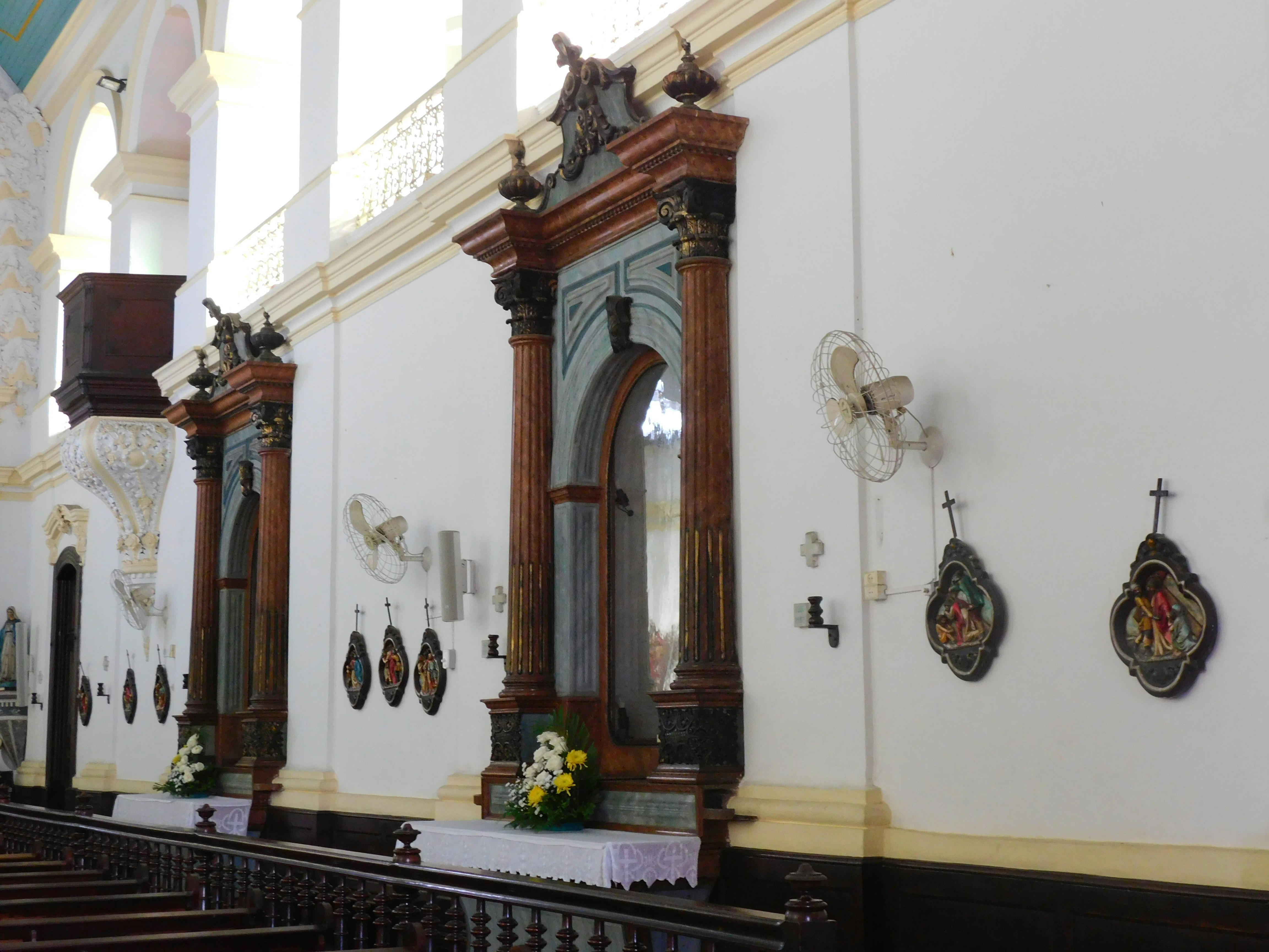 A row of pews in a church with stained glass windows