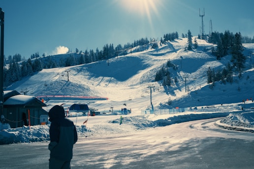 A person standing in front of a snow covered mountain