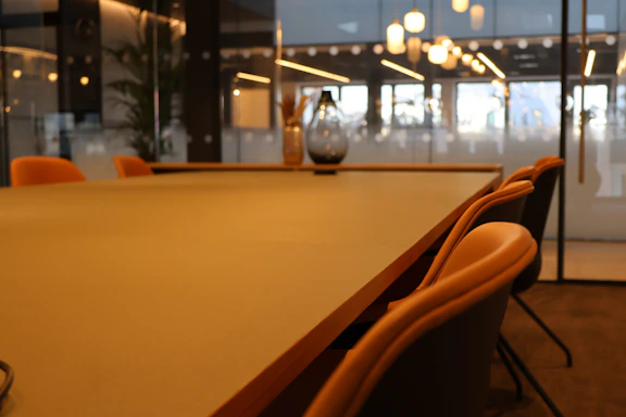 A conference room with a large table and chairs