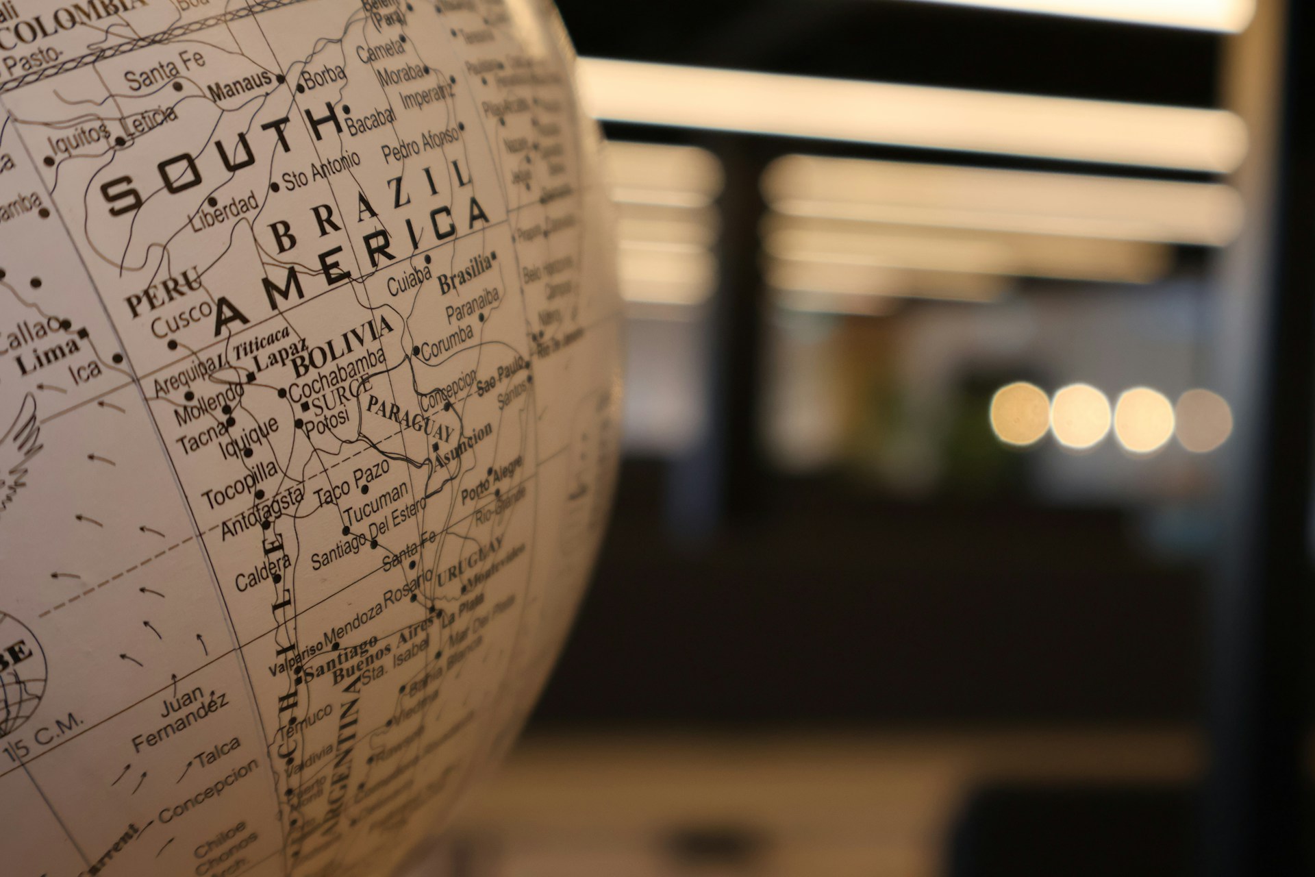 A close up of a globe with a building in the background