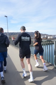 A group of people walking across a bridge