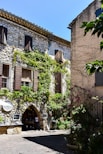 A stone building with vines growing on the side of it