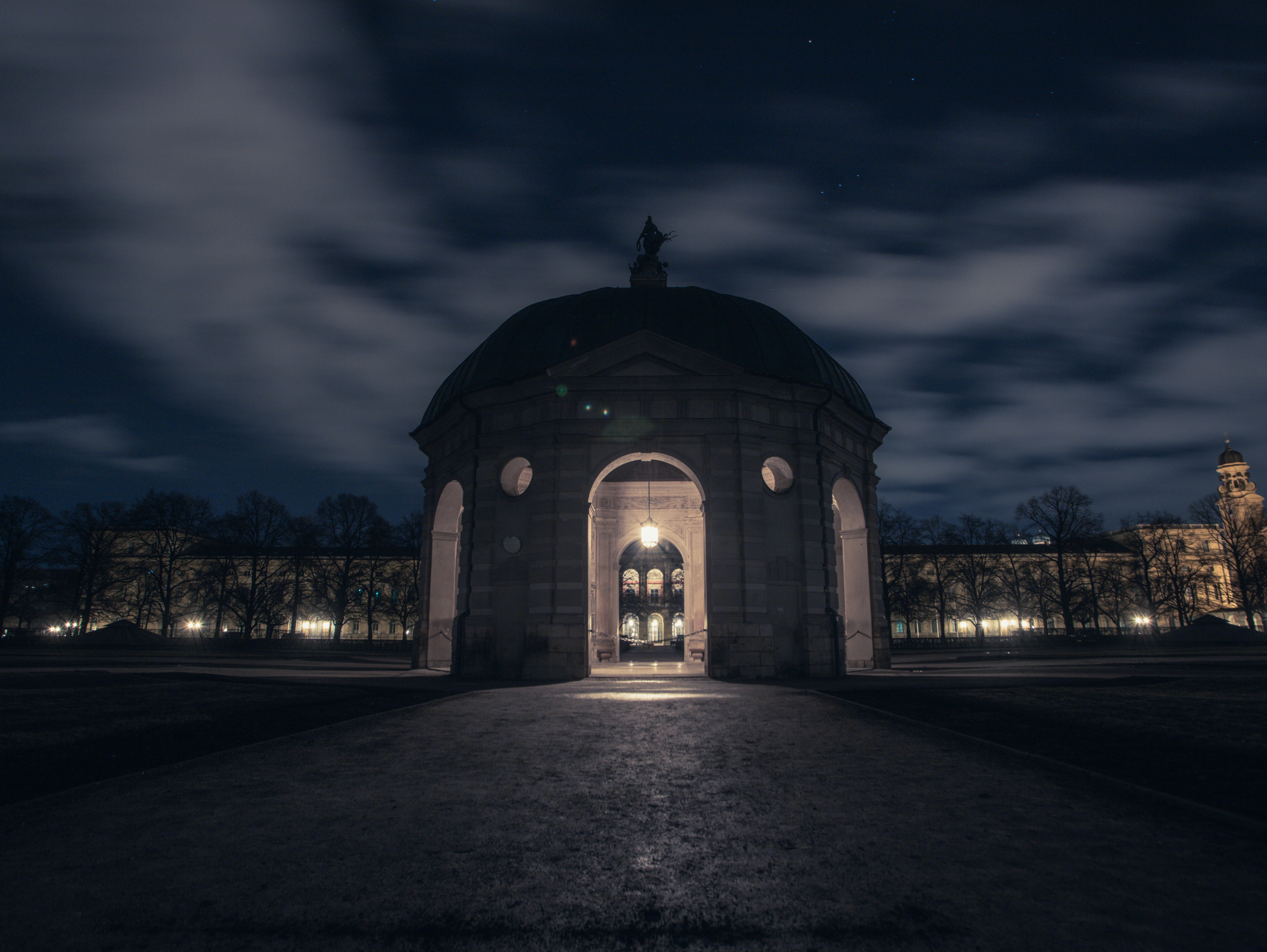 A night time photo of a building with a clock tower