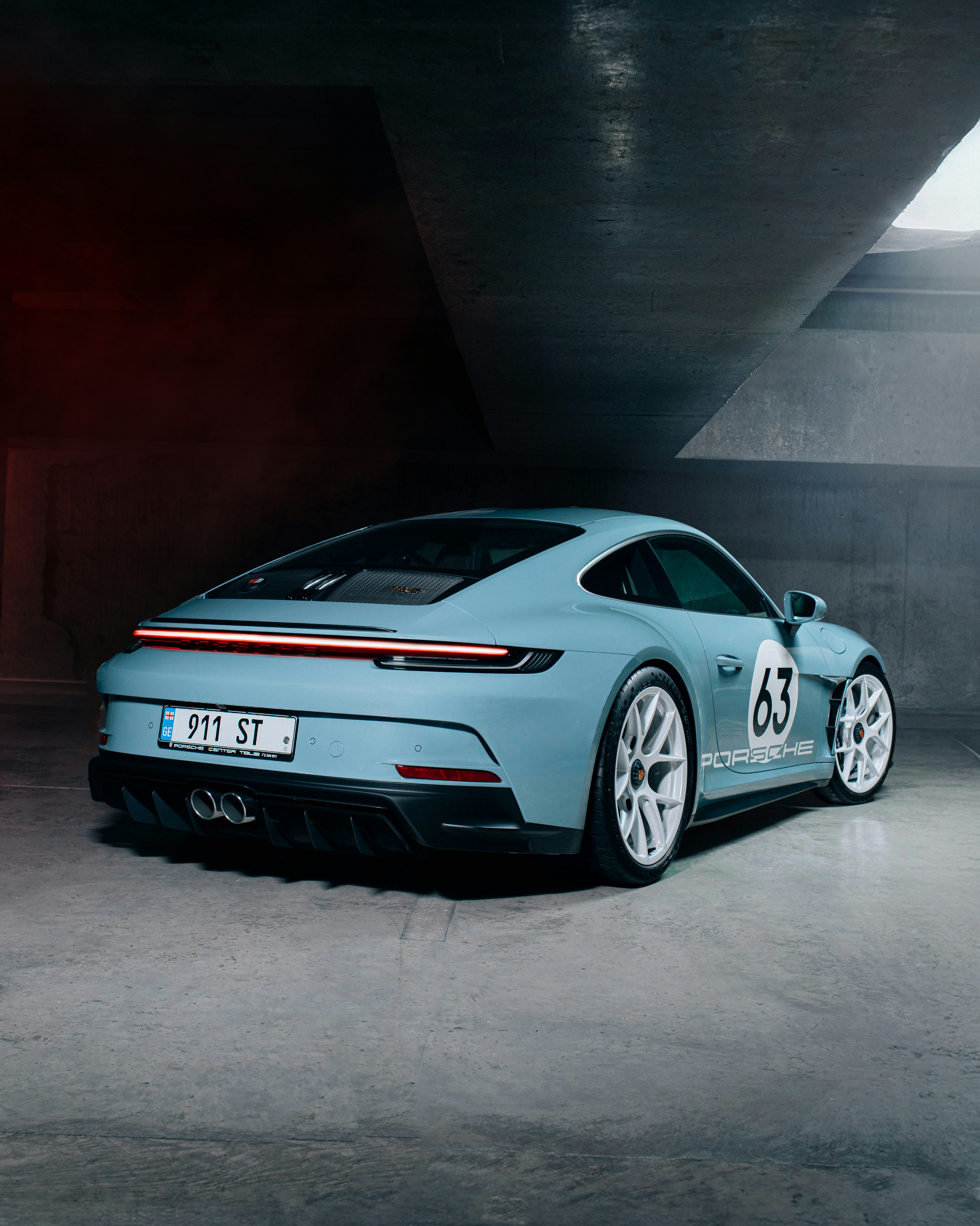 A blue sports car parked in a parking garage