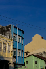 A street sign in front of a row of buildings