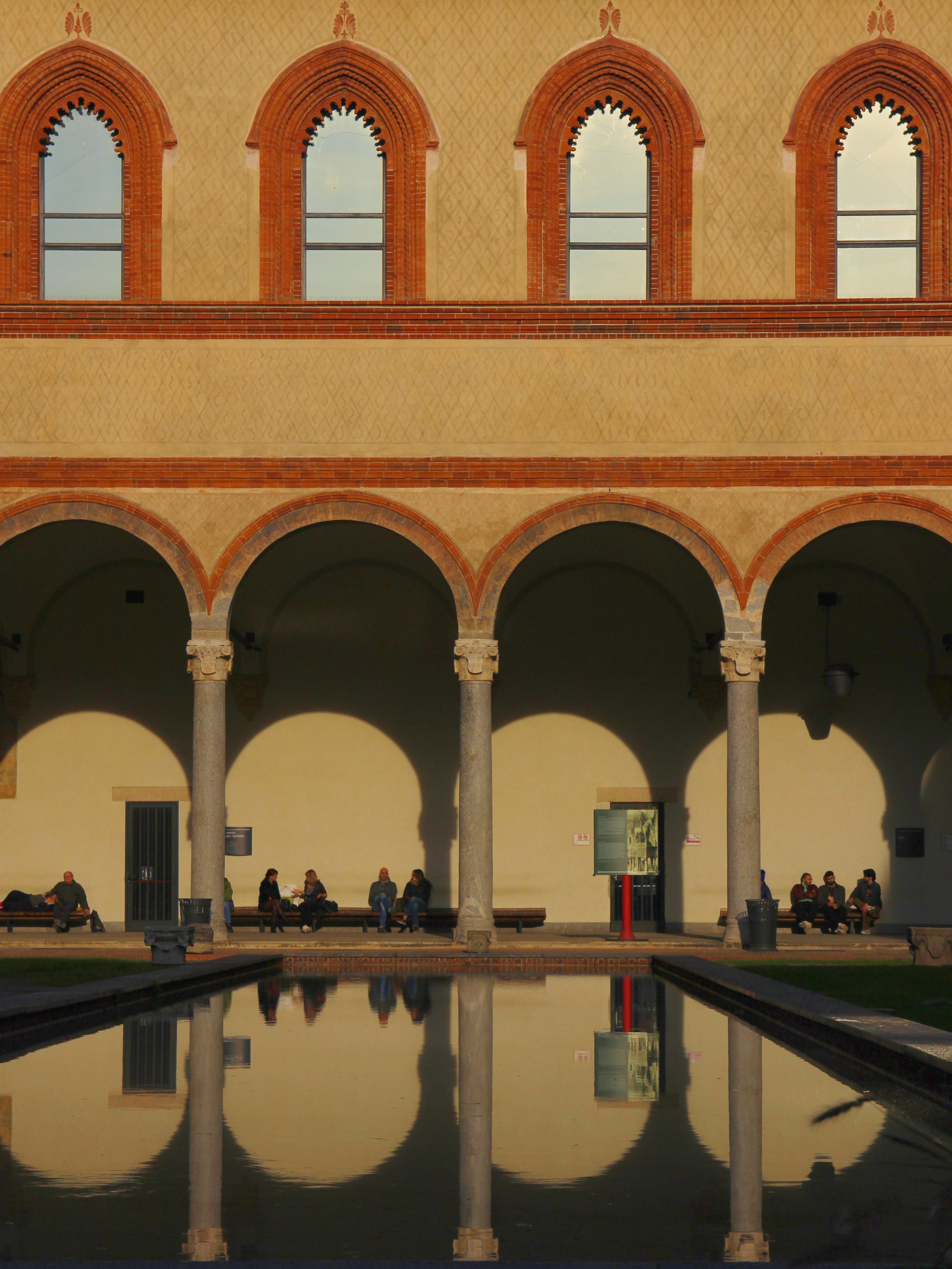 A large building with a pool in front of it