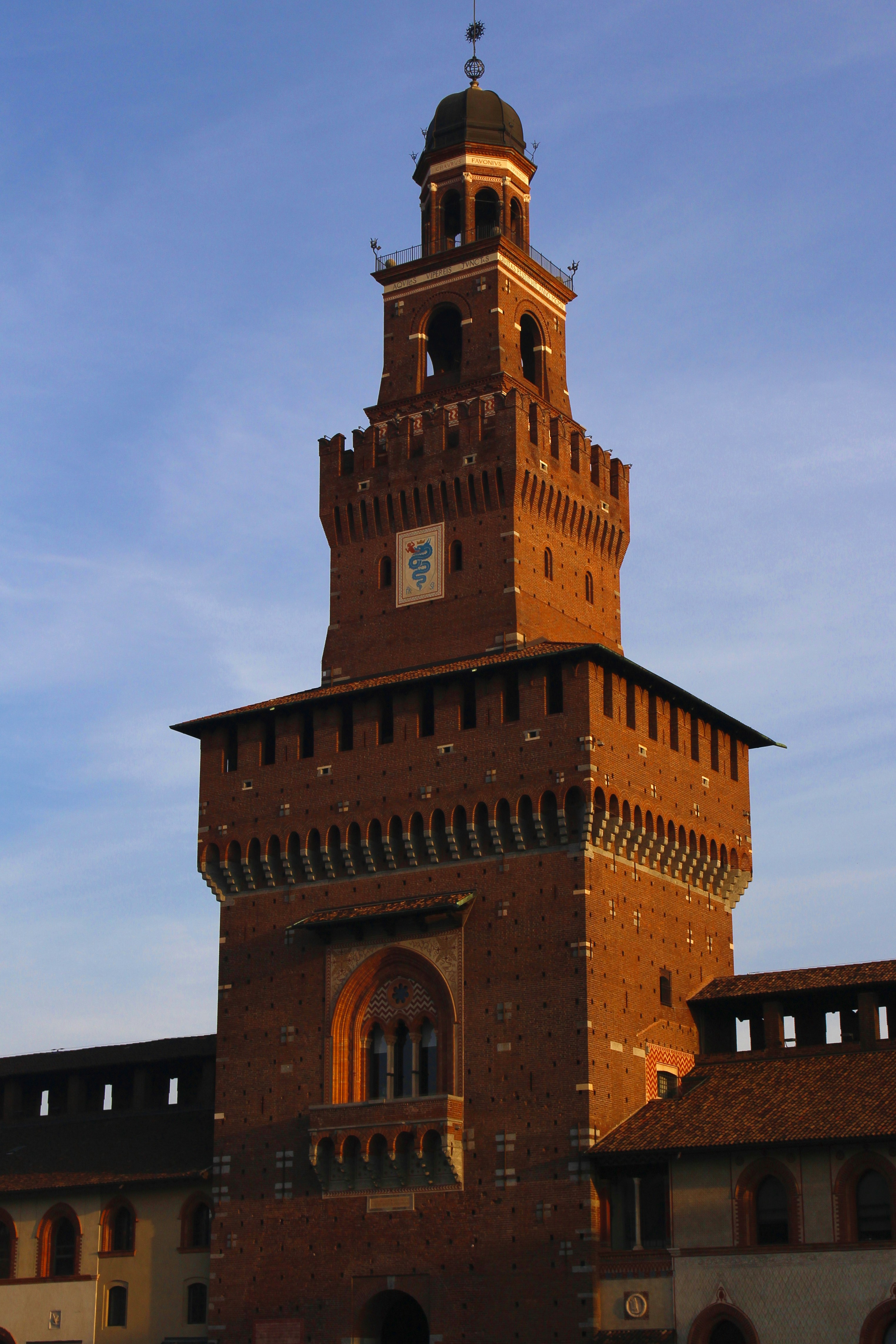 A tall brick tower with a clock on it's side