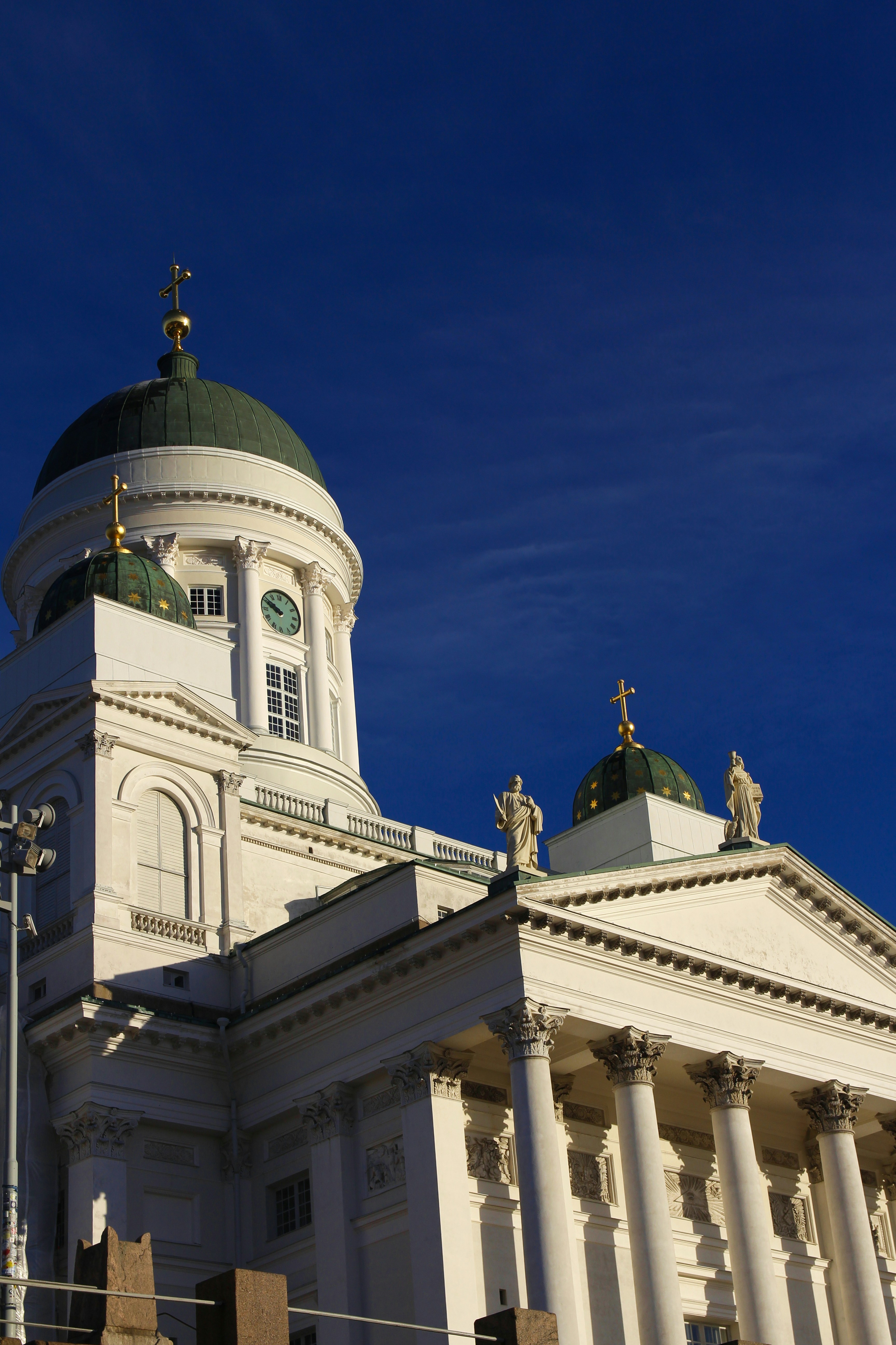 A large white building with a green dome