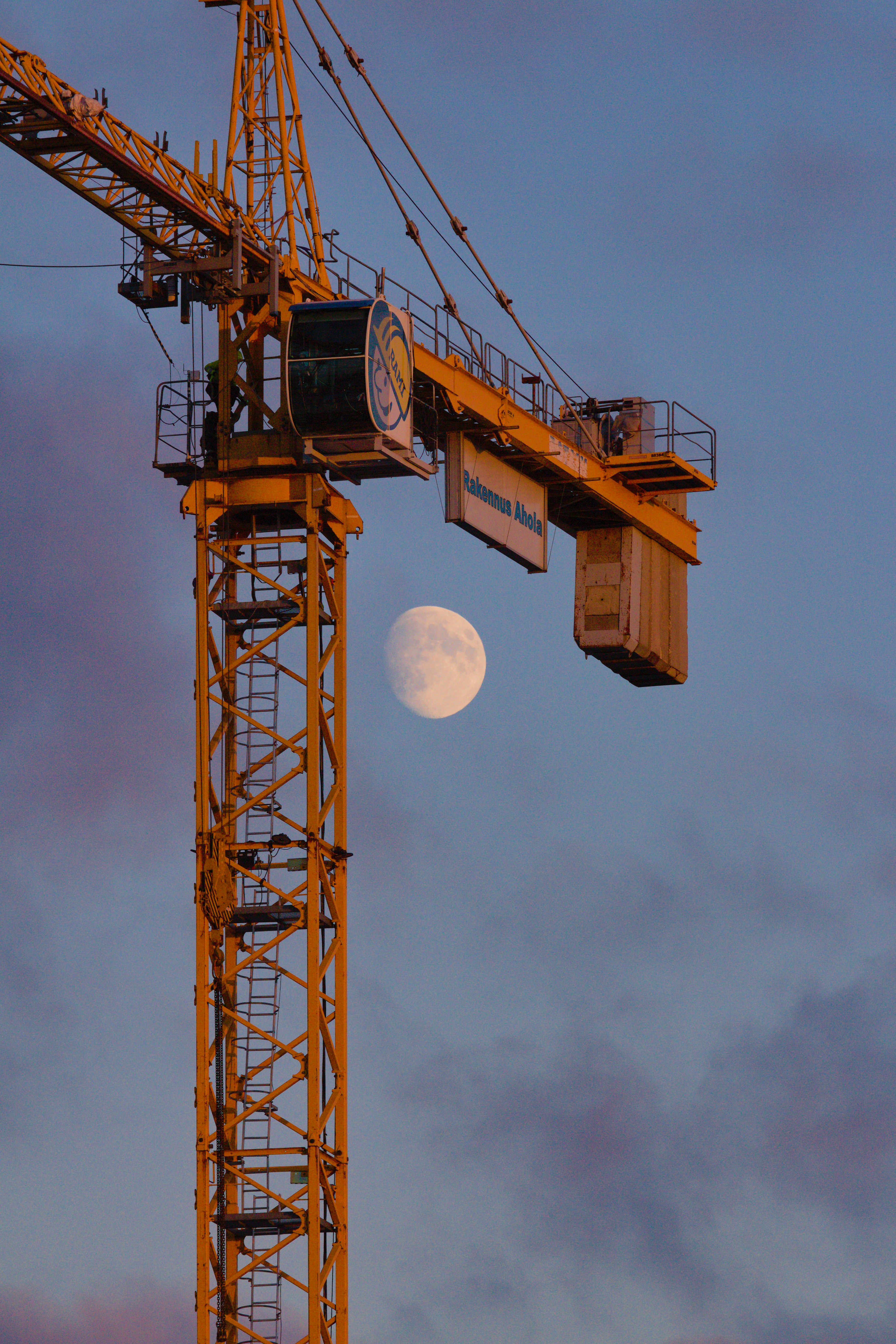 A large crane with a clock on it's side