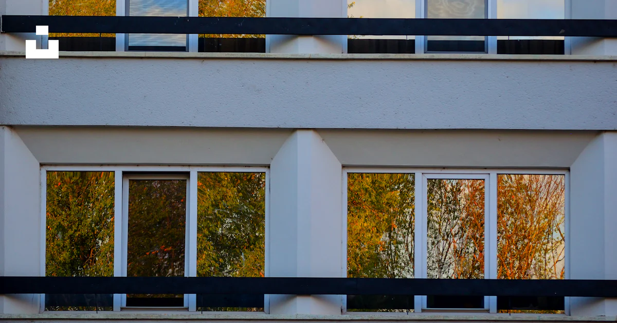 A tall building with lots of windows and balconies photo – Free Window ...