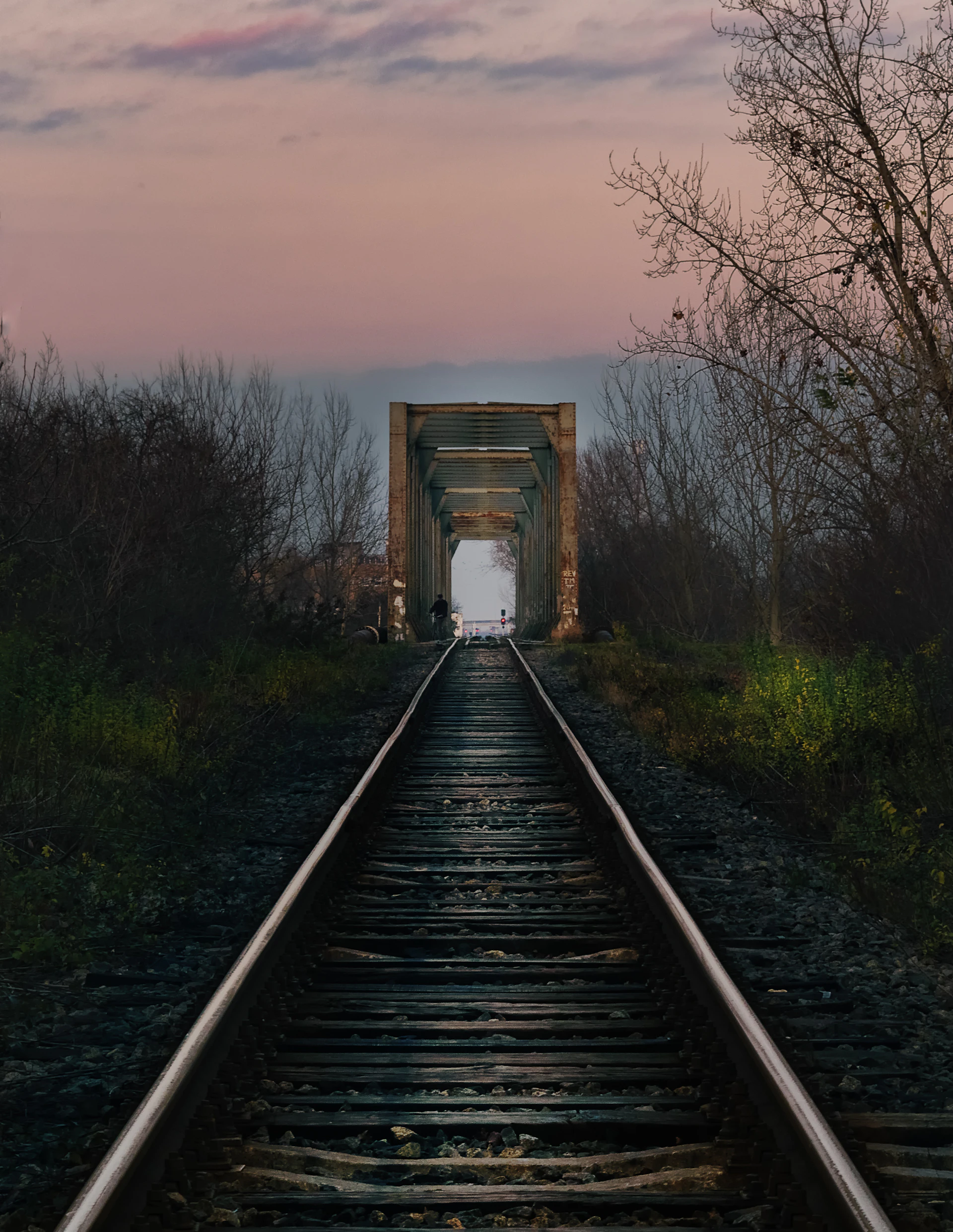 A train track with a light at the end of it