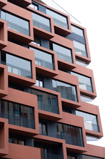 A tall red building with balconies and balconies
