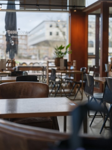 A restaurant with tables, chairs, and umbrellas