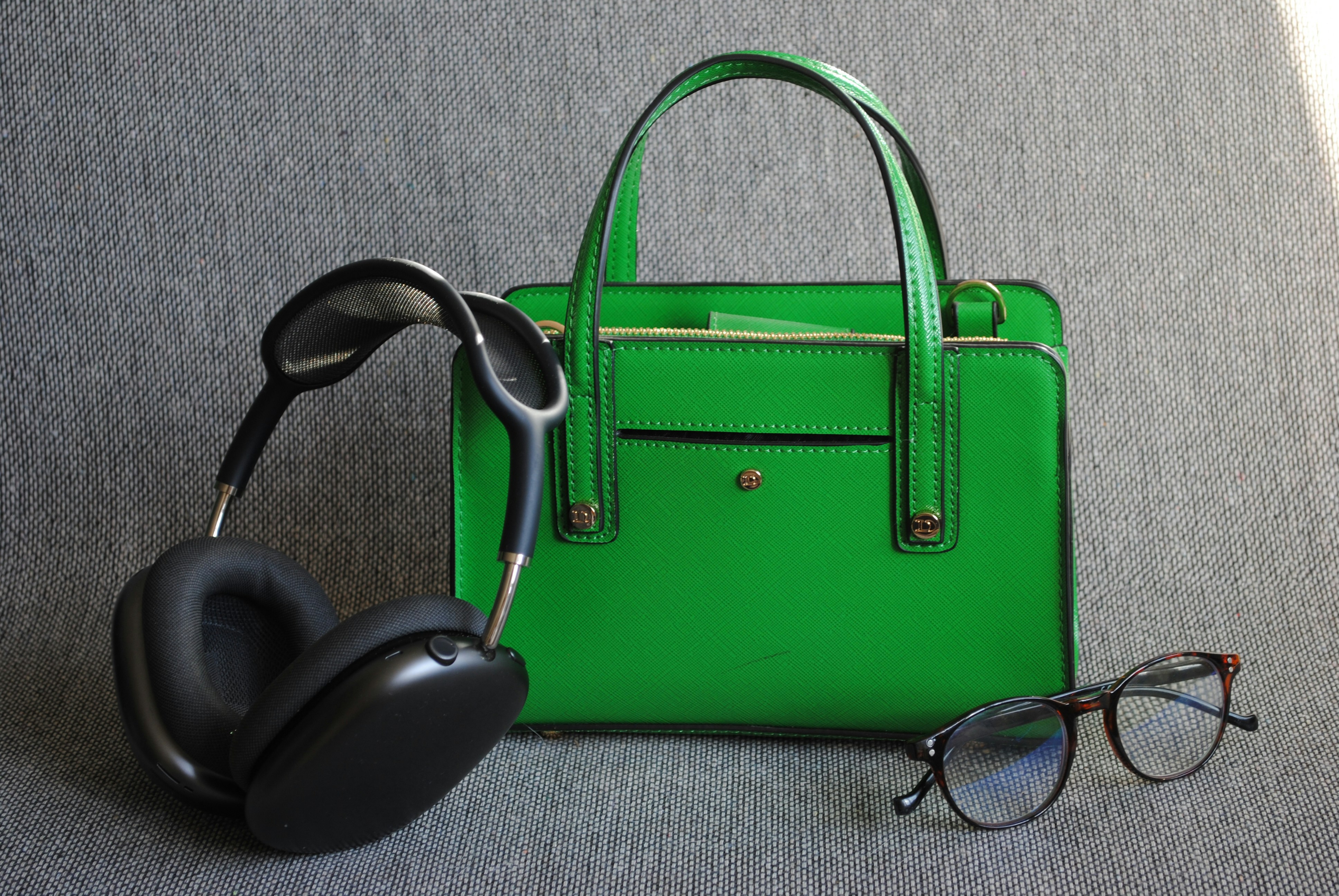 A green bag, headphones, and glasses.