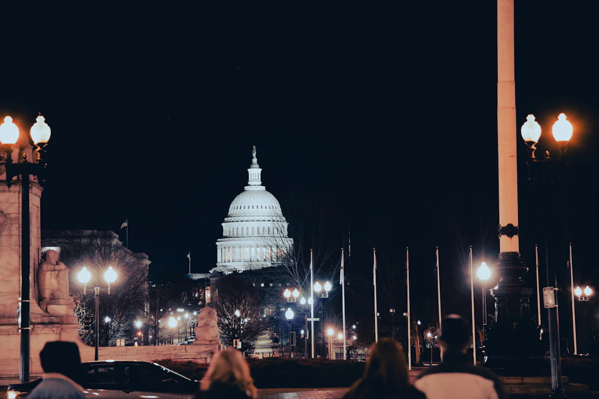 The Capitol illuminated at night — frontier AI policy is now a transatlantic and Indo-Pacific conversation, not only a domestic one.