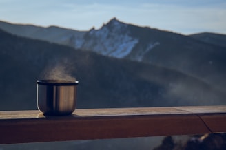 Warm drink overlooking majestic mountains.