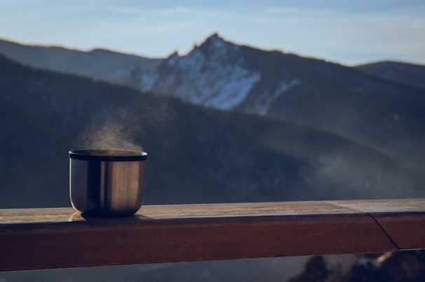 Warm drink overlooking majestic mountains.