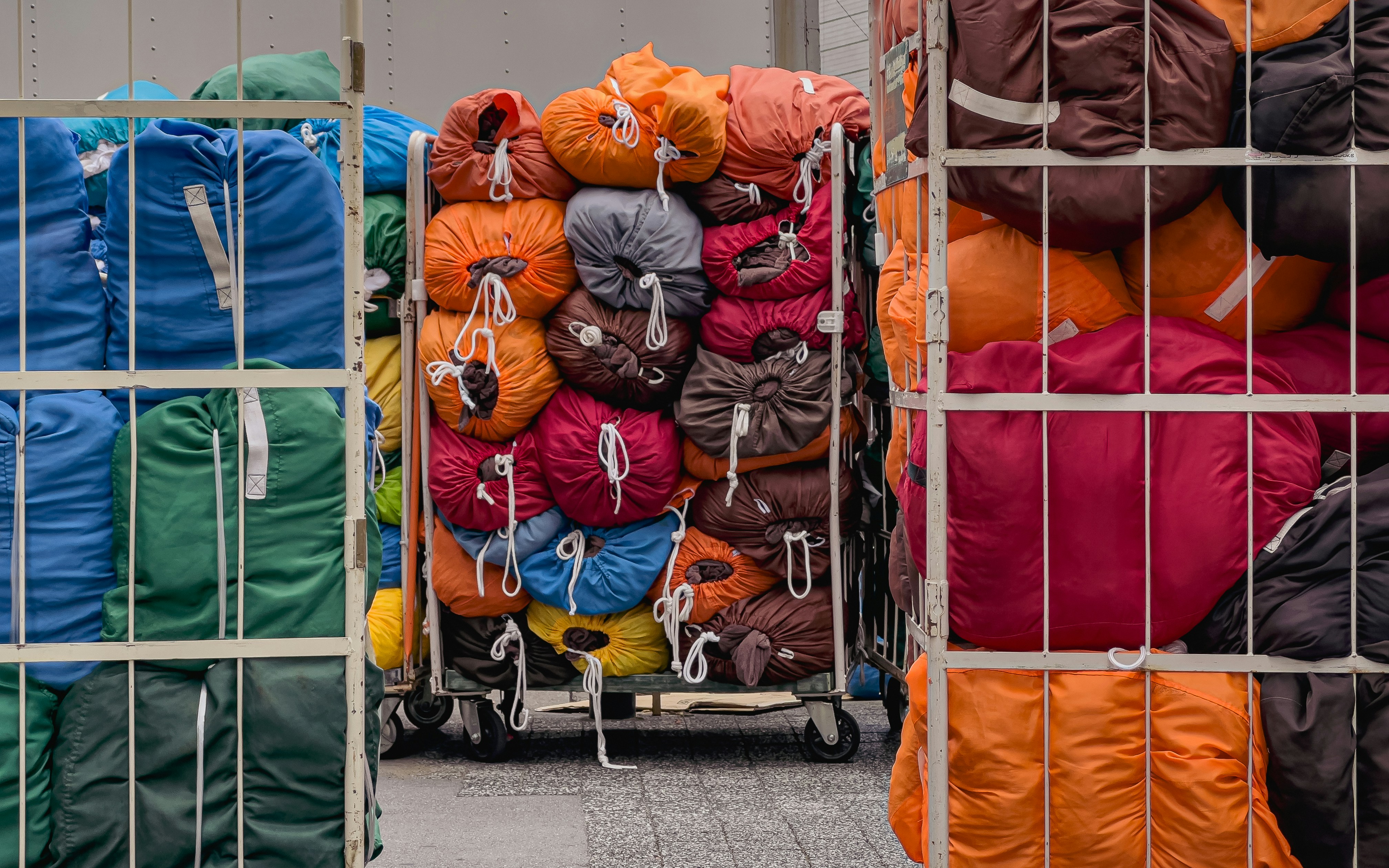 A bunch of bags are stacked on a cart, 