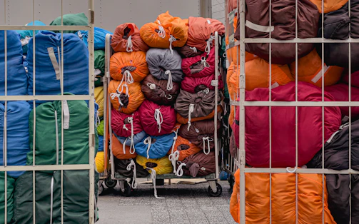 A bunch of bags are stacked on a cart