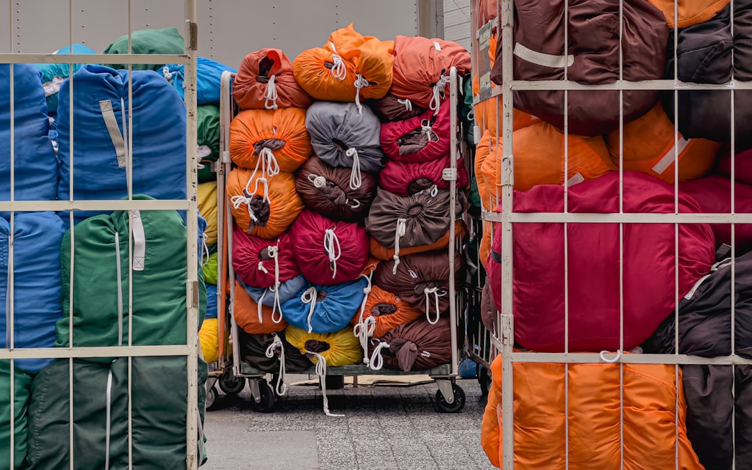 A bunch of bags are stacked on a cart,