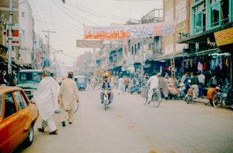 A group of people riding bikes down a street