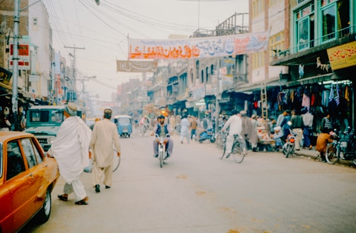 A group of people riding bikes down a street