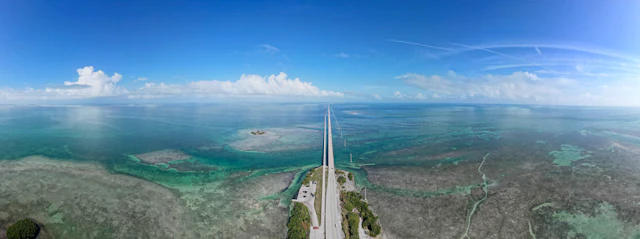 Aerial view of the Overseas Highway running out across the shallow turquoise flats of the Florida Keys
