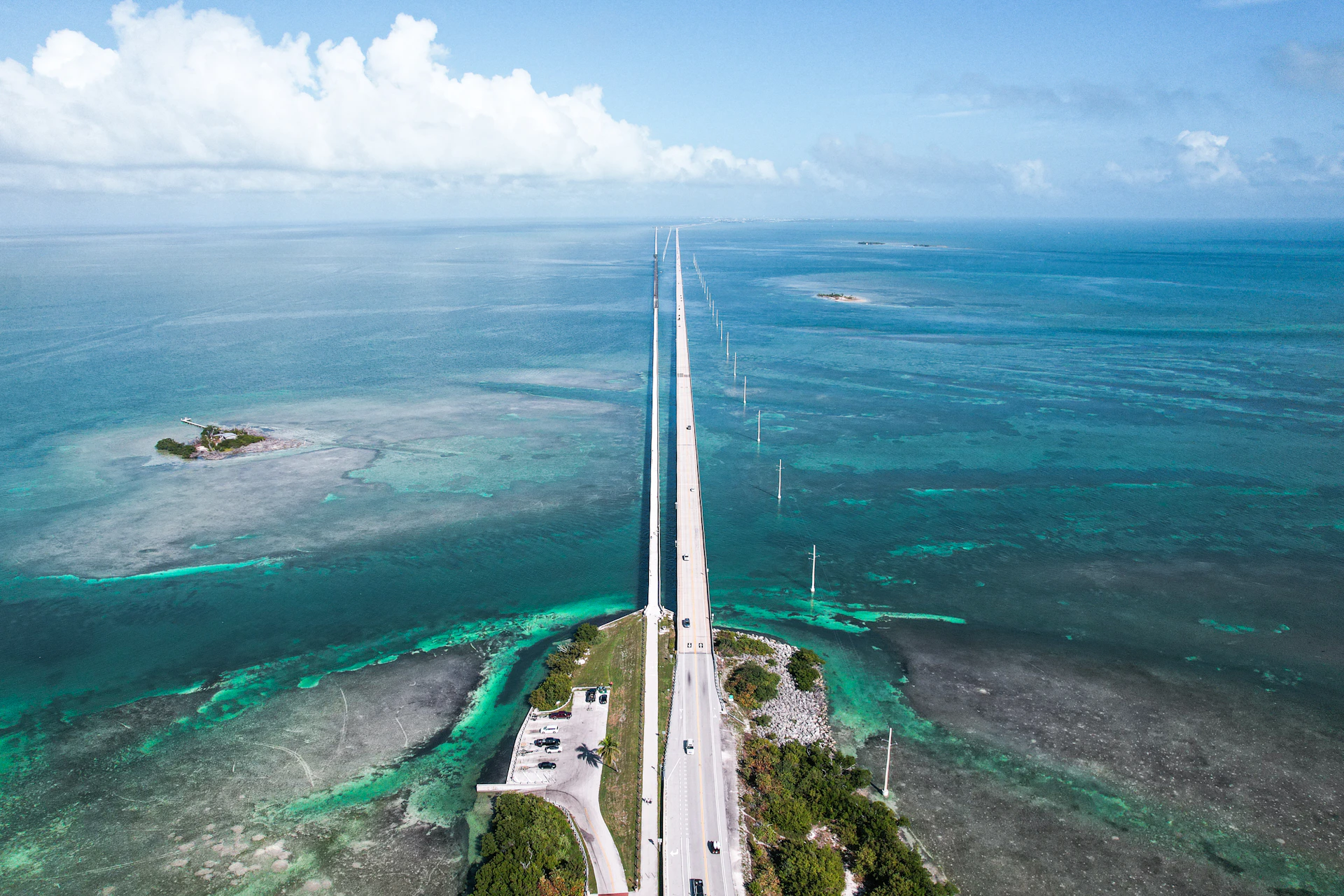 An aerial view of a lighthouse in the middle of the ocean