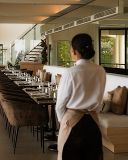 A waitress stands in a modern restaurant.