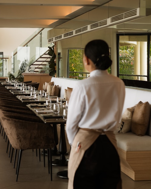 A waitress stands in a modern restaurant.