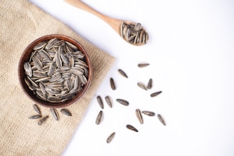 Sunflower seeds in a bowl and on a spoon.