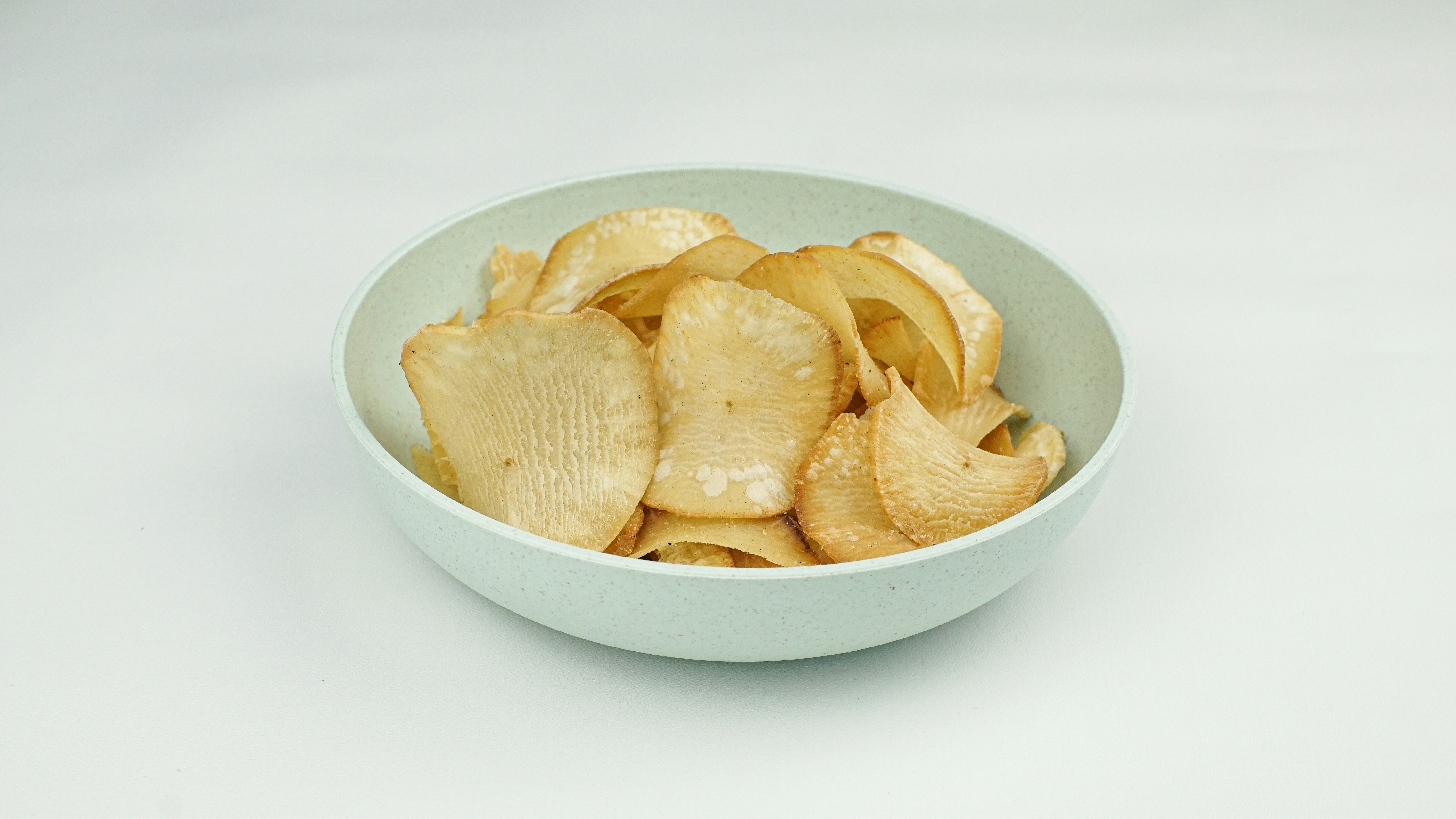 A bowl of crunchy potato chips.