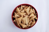 A bowl of delicious triangular pastries.